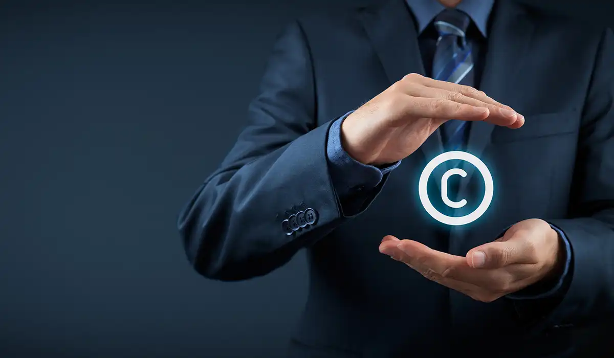 Intellectual property rights drive innovation - copyright symbol between two hands