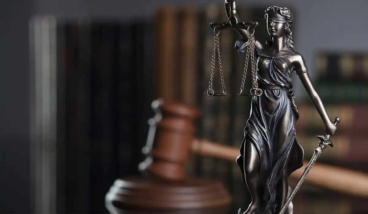 Class action lawsuit settlements taxable - Gavel of the judge and statue of the justice